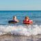 Two boys body boarding together Broomhill Manor Holiday Cottages for rent in Bude North Cornwall